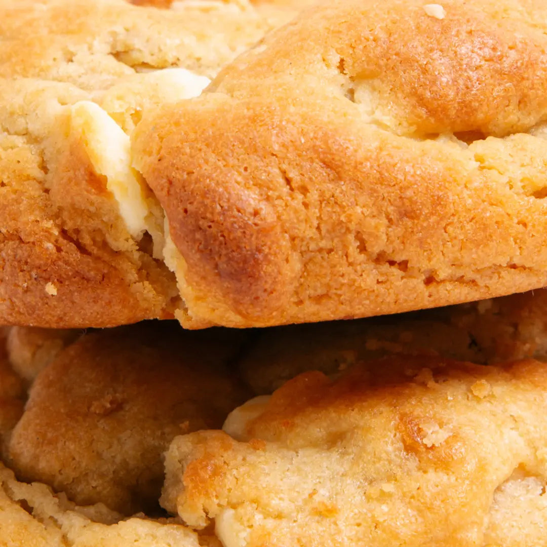 Close-up of a stack of golden-brown biscuits with a soft texture.