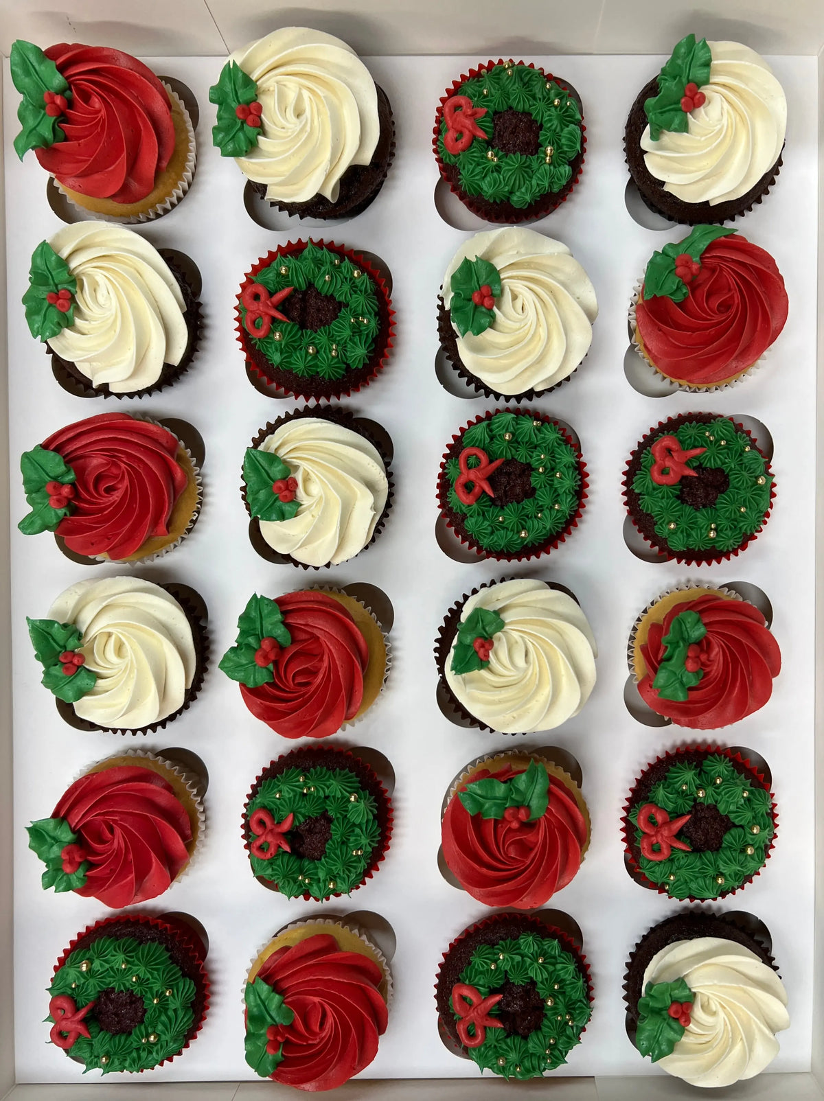 Box of Brooki Christmas cupcakes with wreath frosting